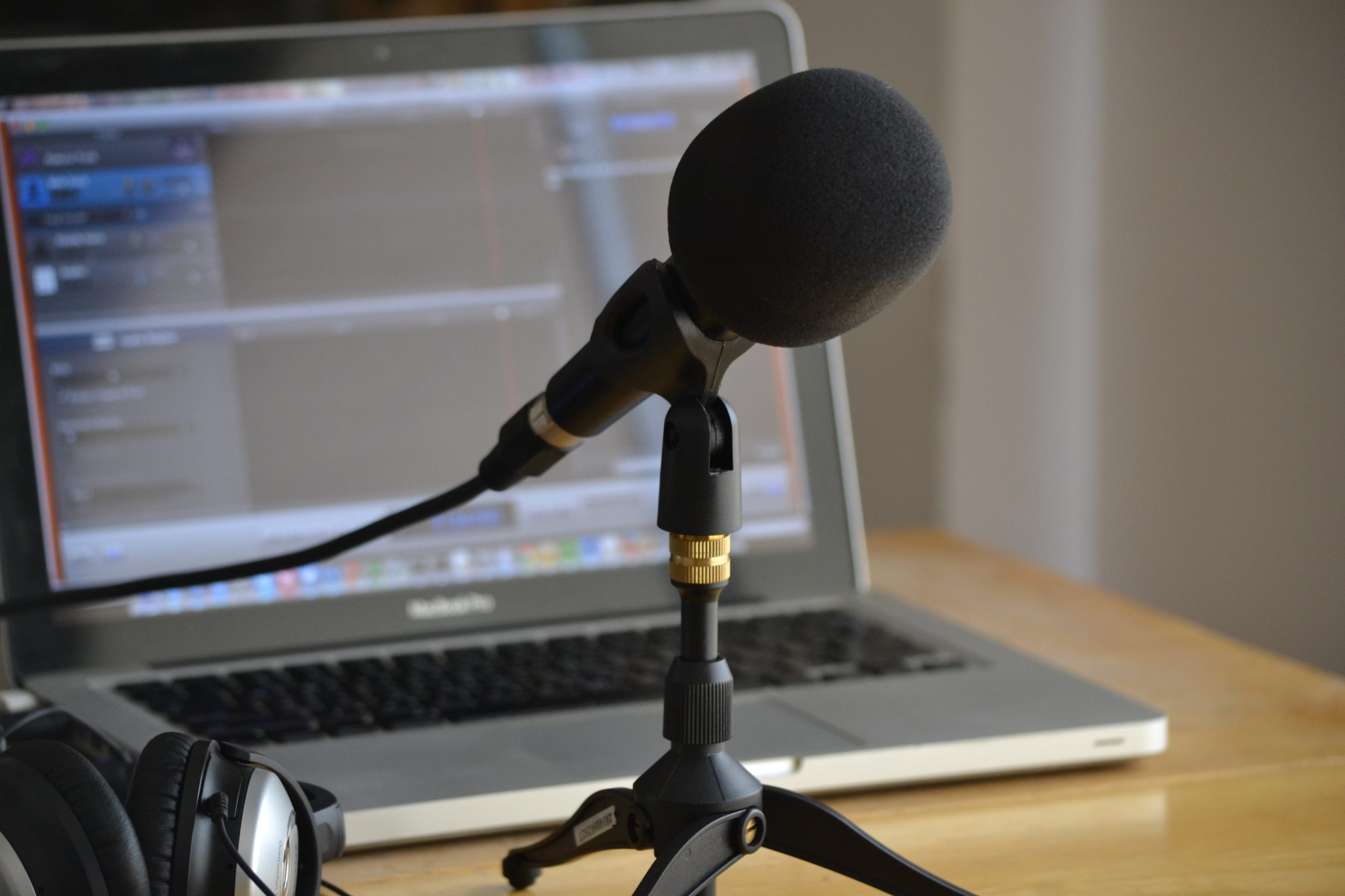 Podcasting setup with a microphone and laptop