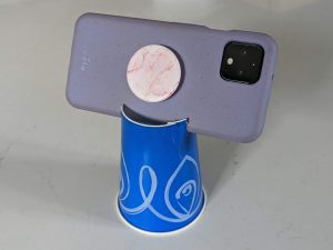 A phone tripod made out of a cardboard cup.